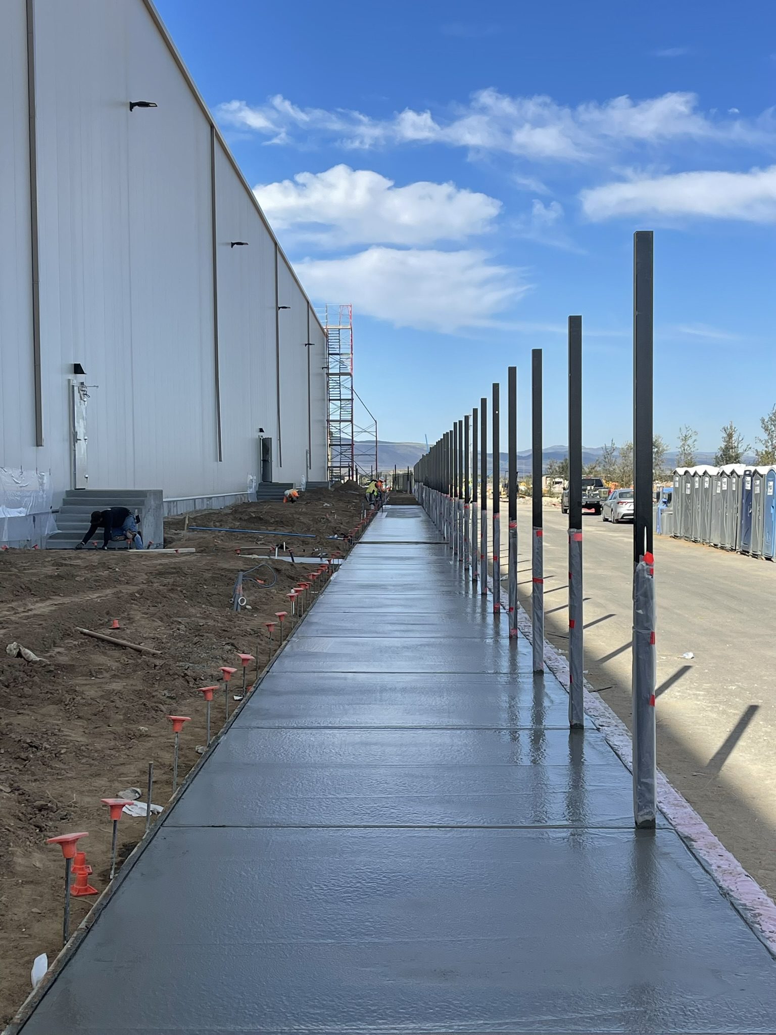 A walkway with metal posts and concrete