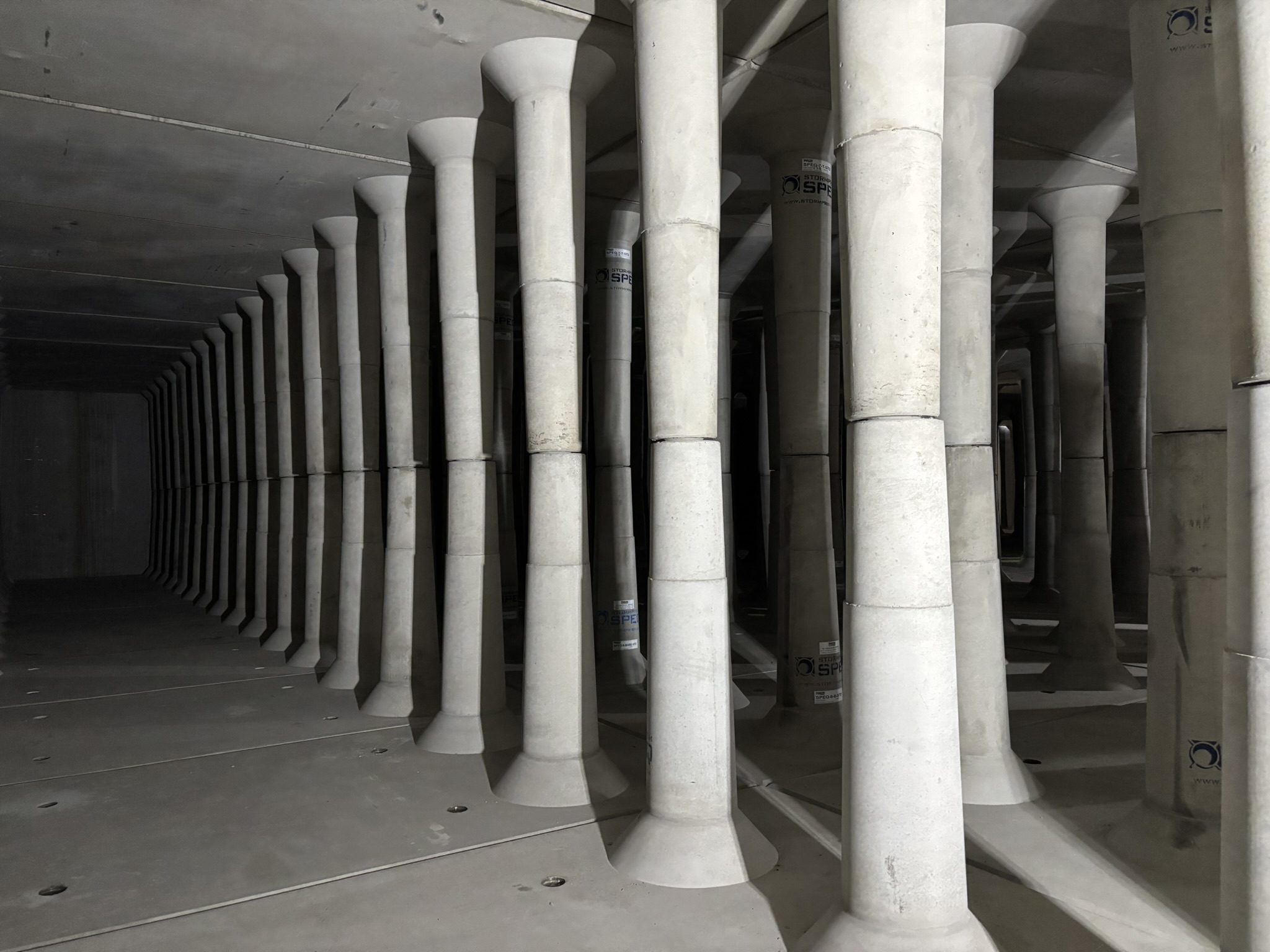 A long row of pillars in the middle of an empty room.