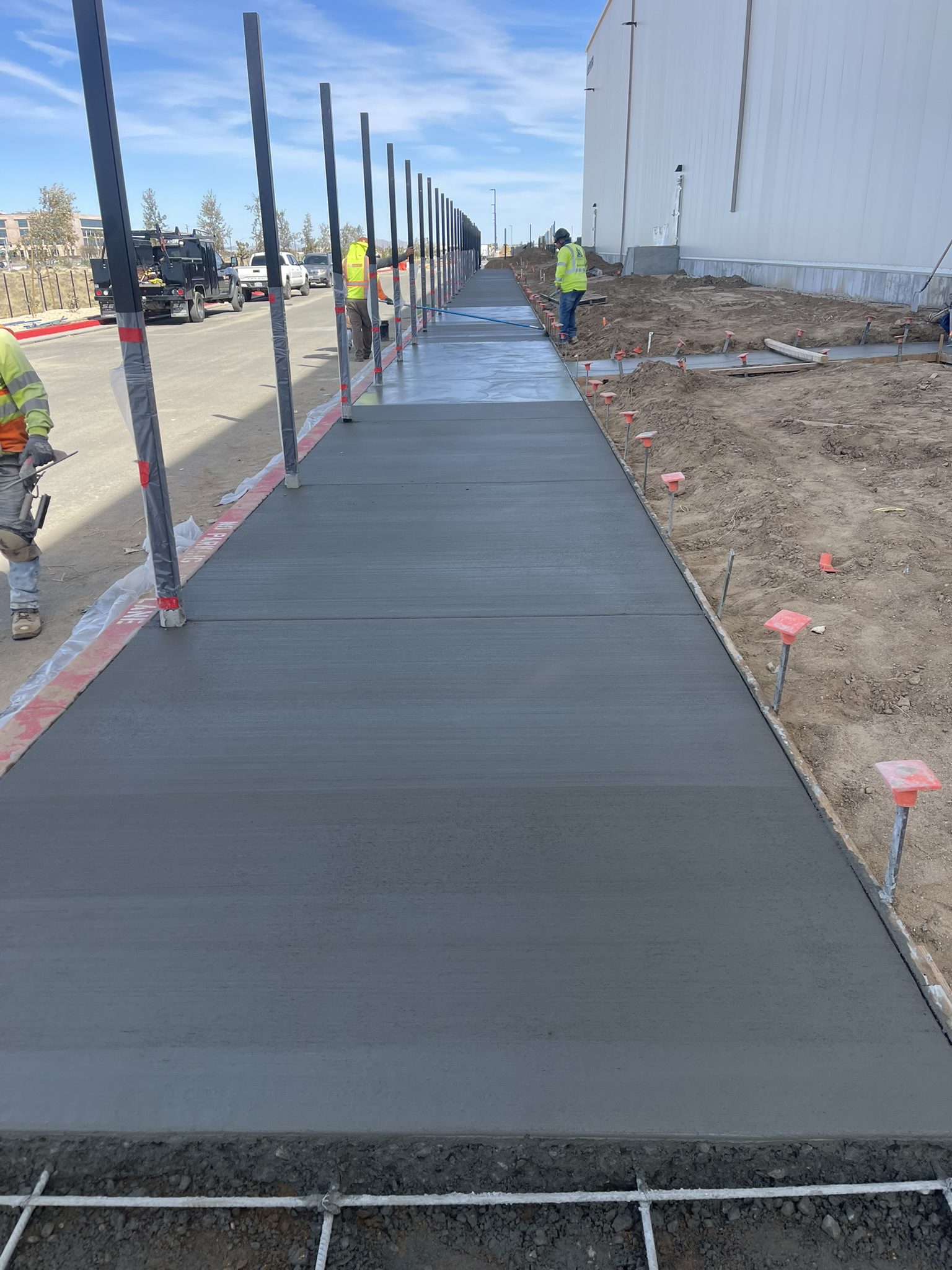 A walkway with cement on the side of it.
