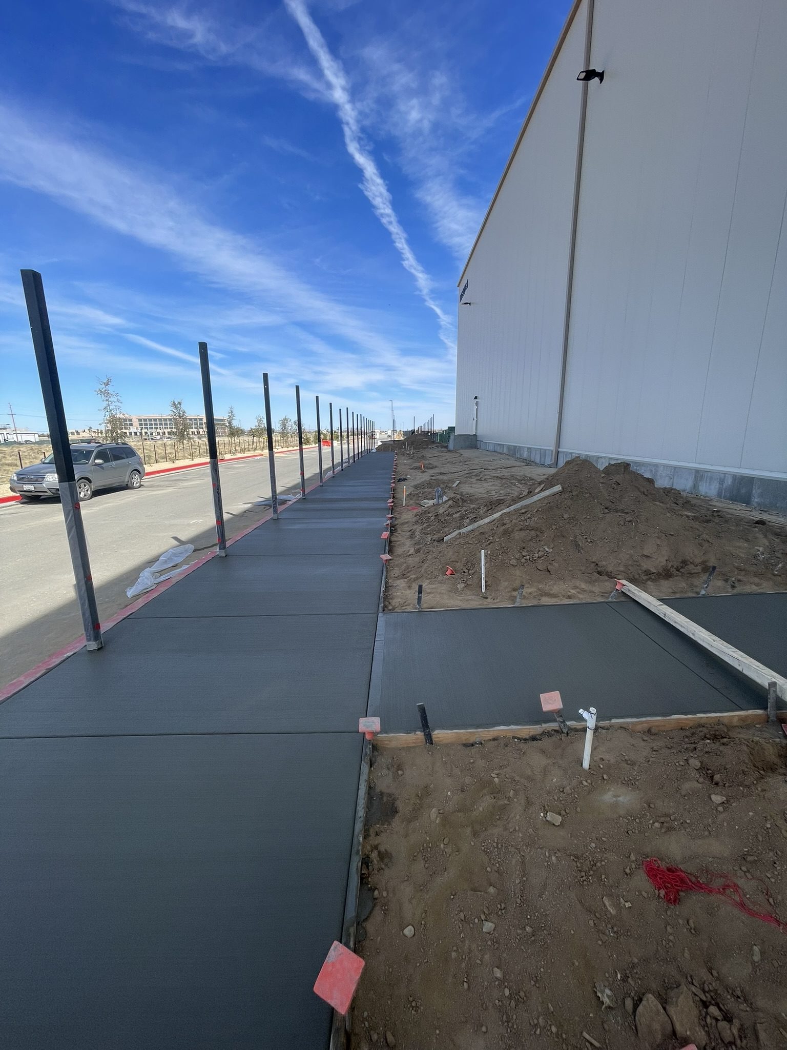 A sidewalk that has been laid out and is being poured.