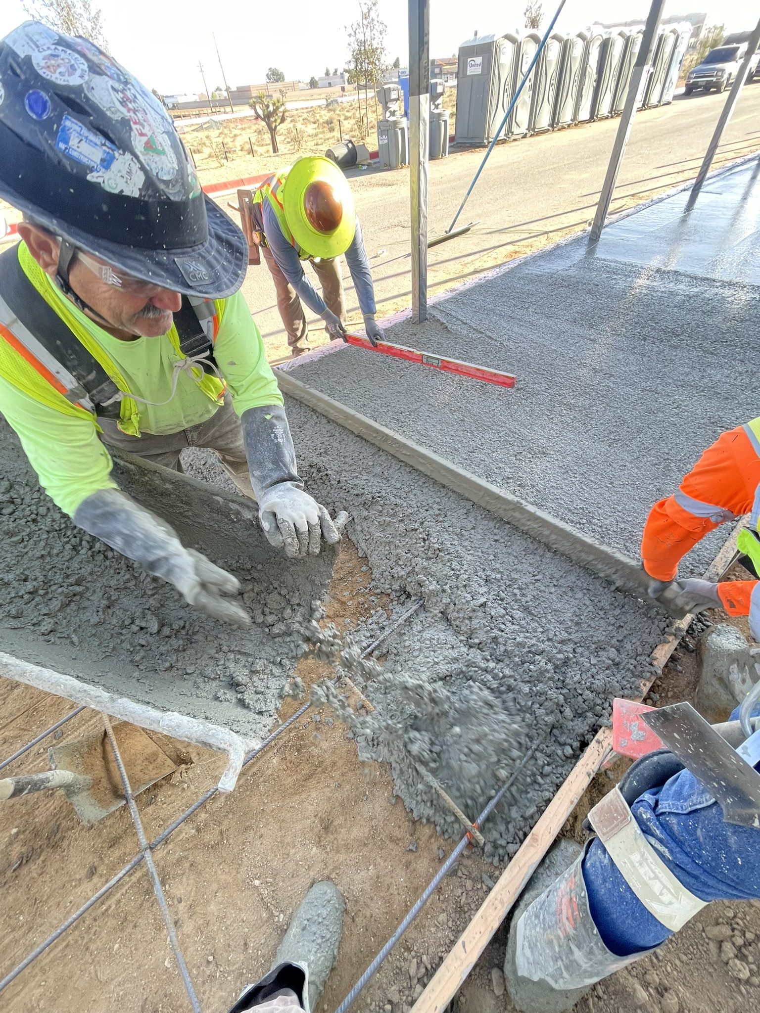 A group of people working on concrete.
