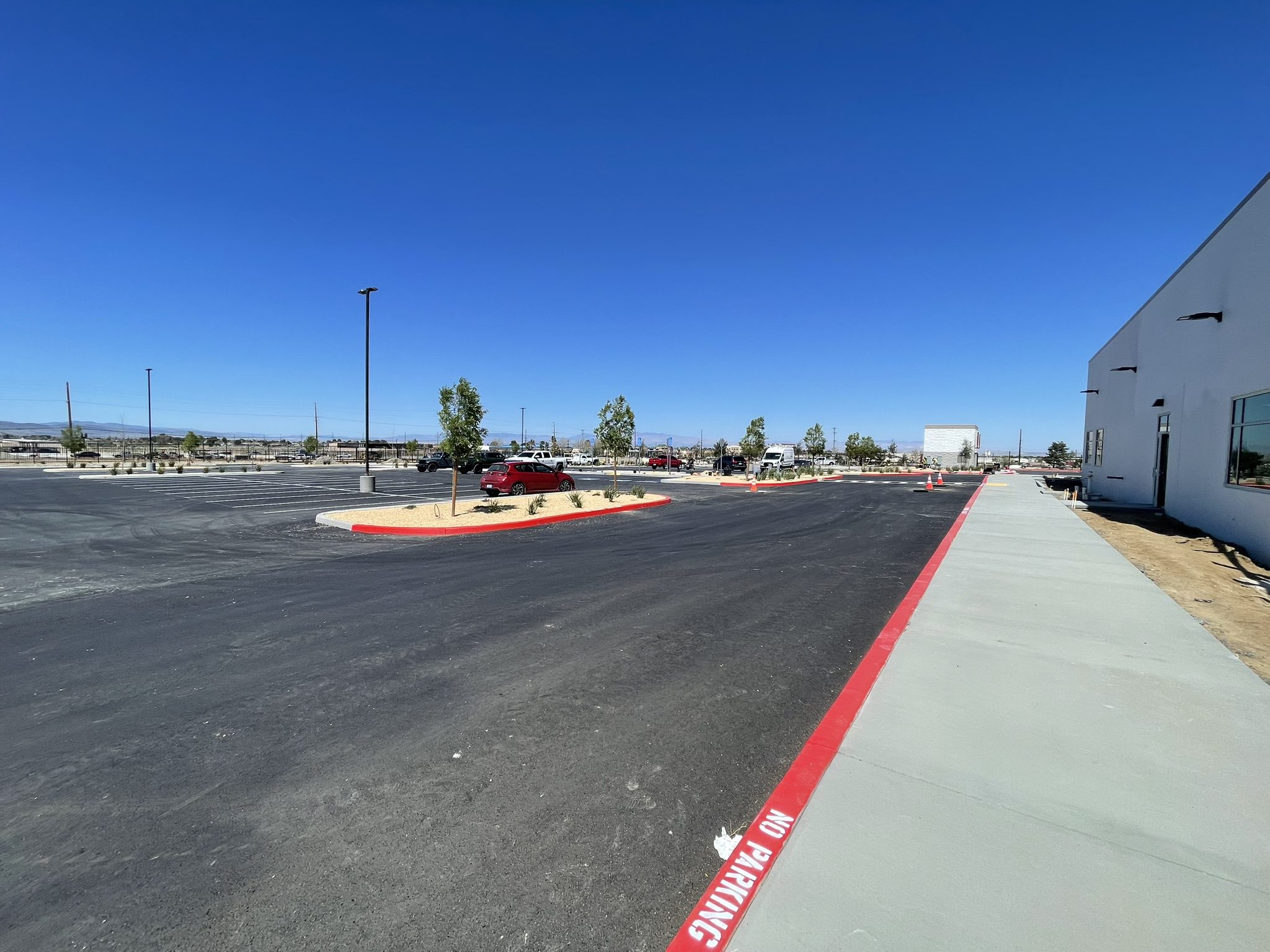 A parking lot with red lines on the side of it.
